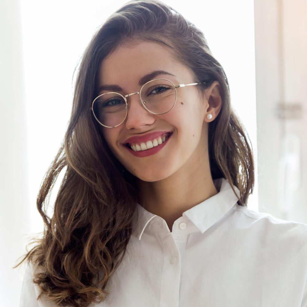 beautiful-smiling-businesswoman-with-eyeglasses-2F9GDZX.jpg